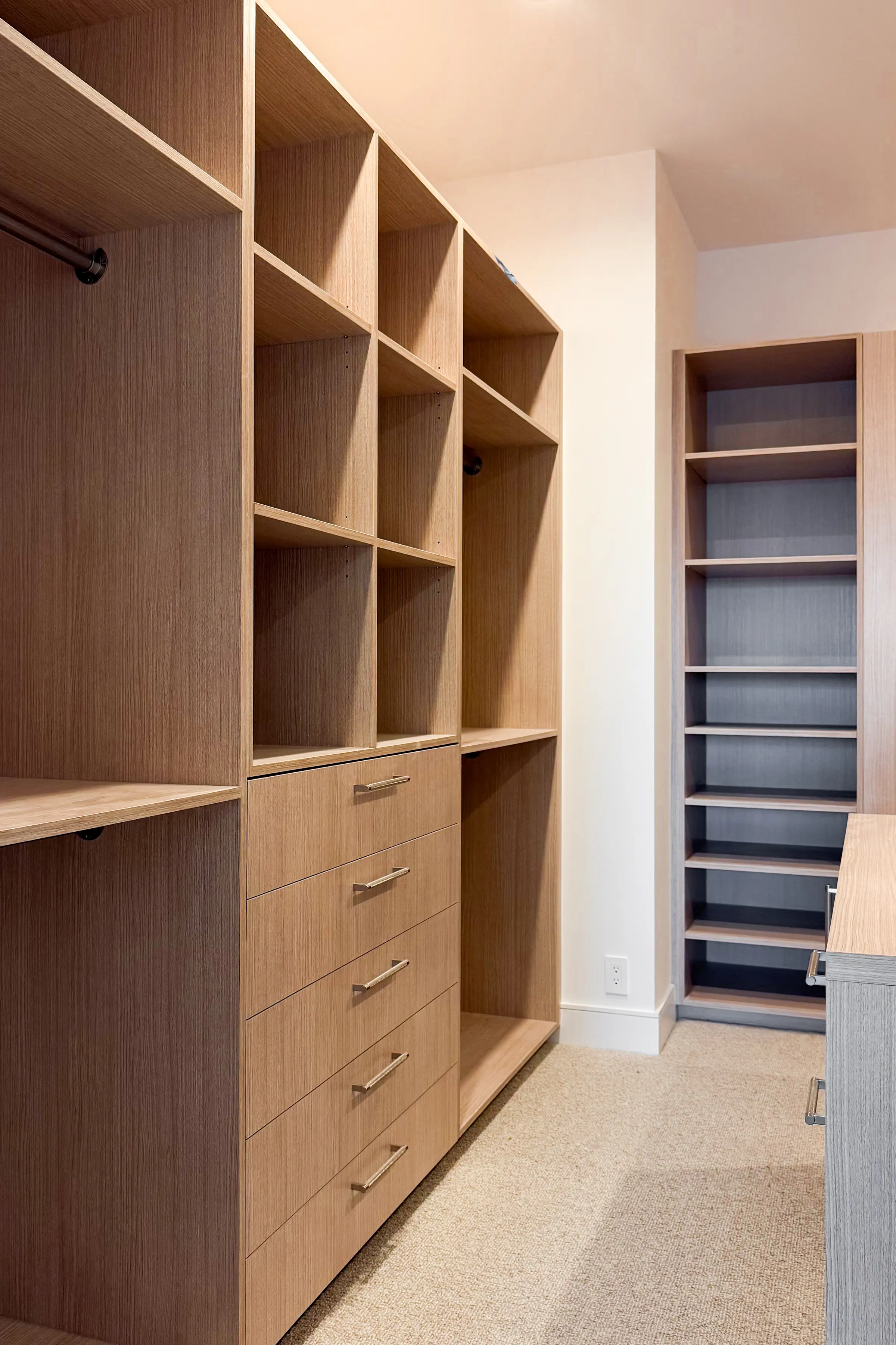 Walk-in closet with full-height oak cabinetry, open shelving, five drawers and a tall shoe tower