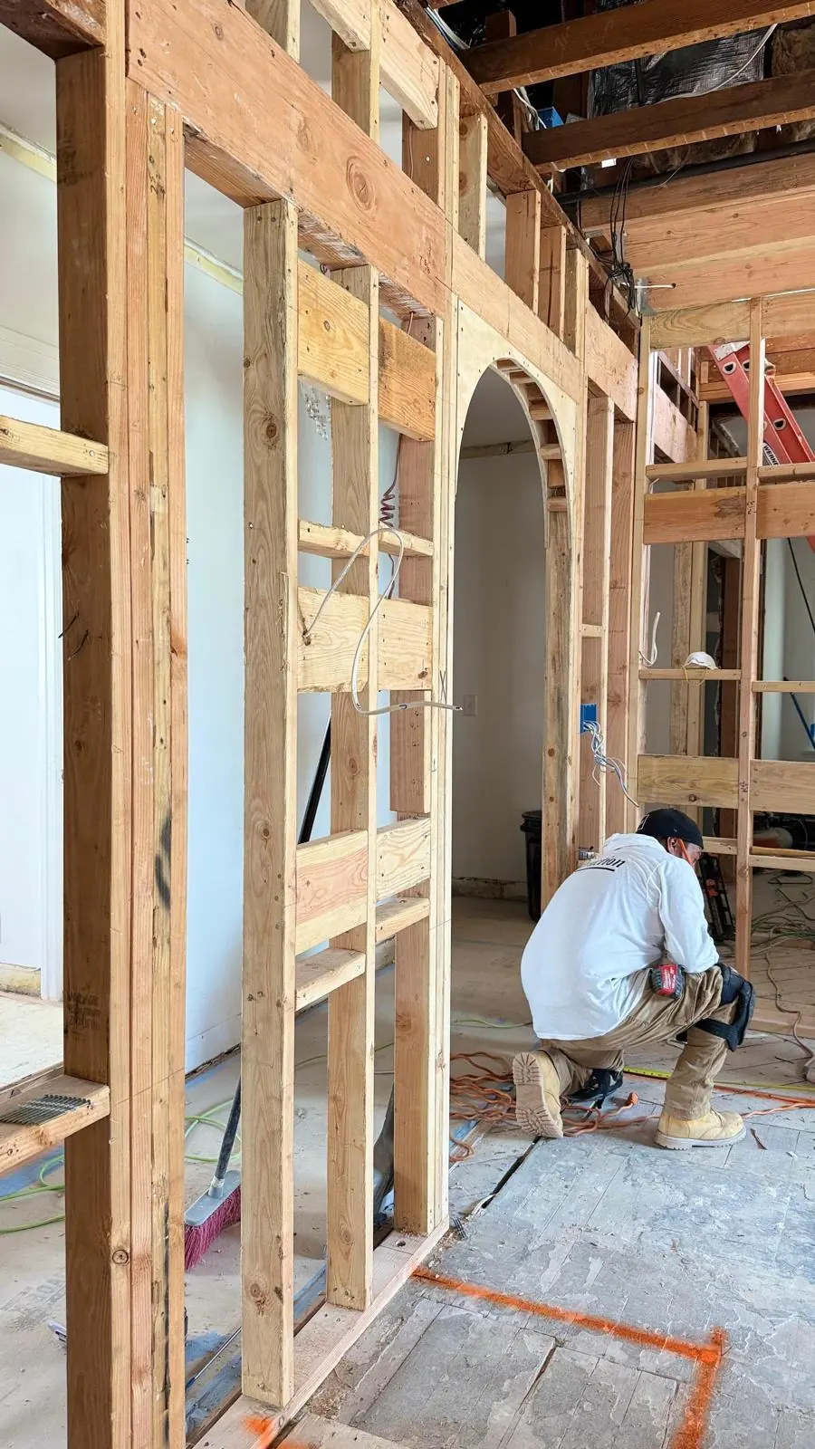 Residential construction progress with framing and exterior work underway