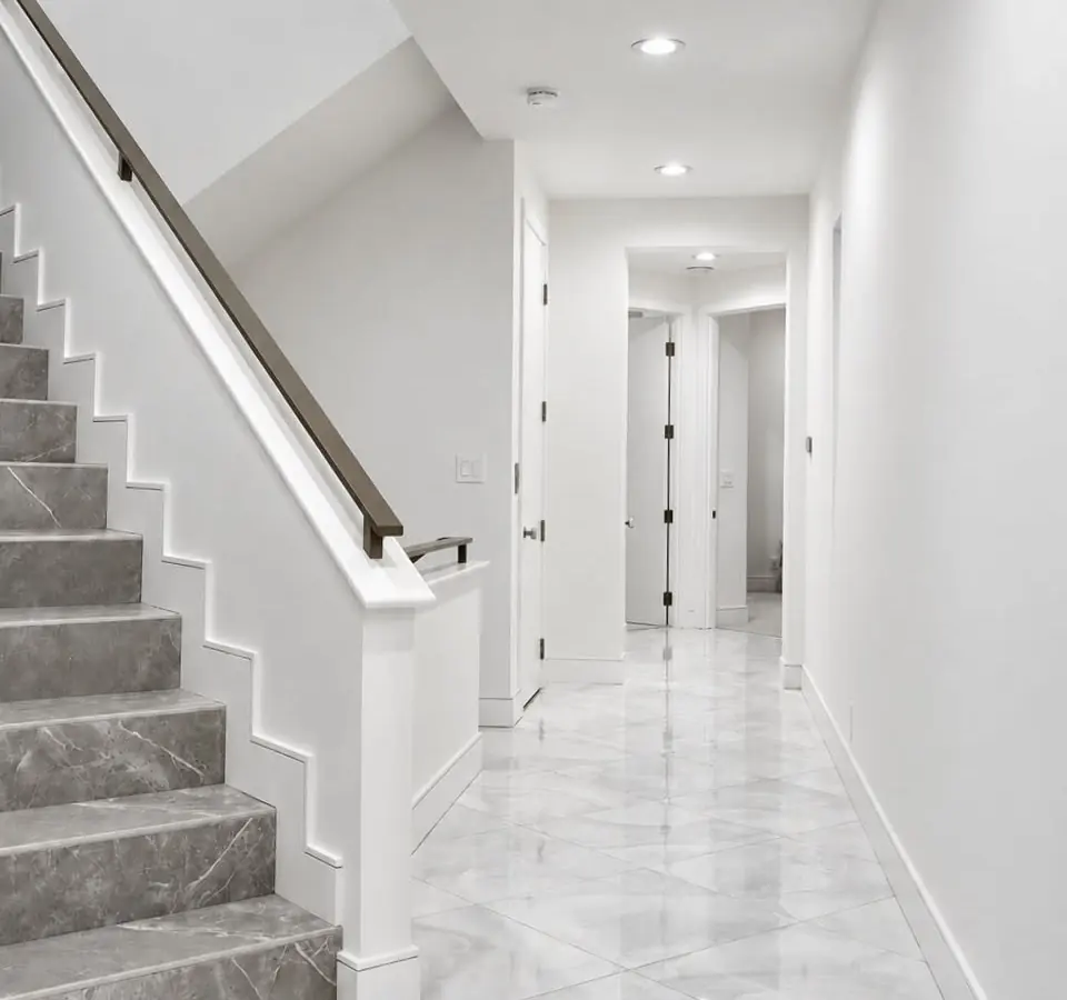 Stair hall before finish work, with construction surfaces still in progress